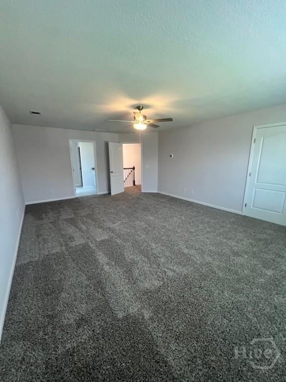 139 Sams Dr, Guyton, GA 31312 - unfurnished bedroom featuring baseboards, carpet, a textured ceiling, and a ceiling fan
