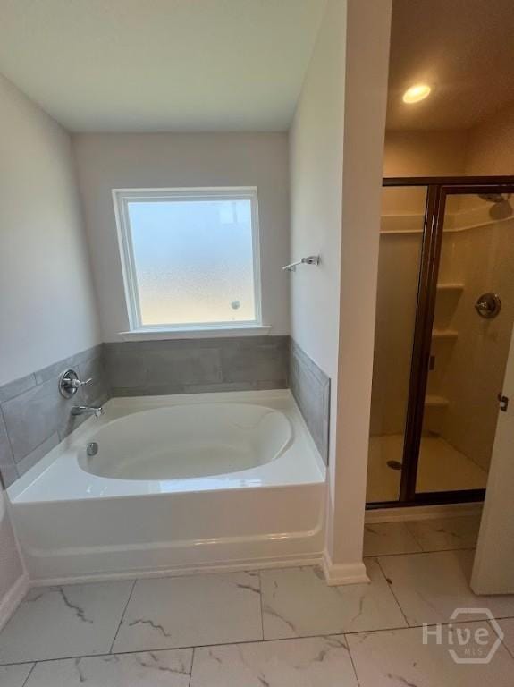 139 Sams Dr, Guyton, GA 31312 - full bath featuring marble look tile flooring, a bath, and a stall shower