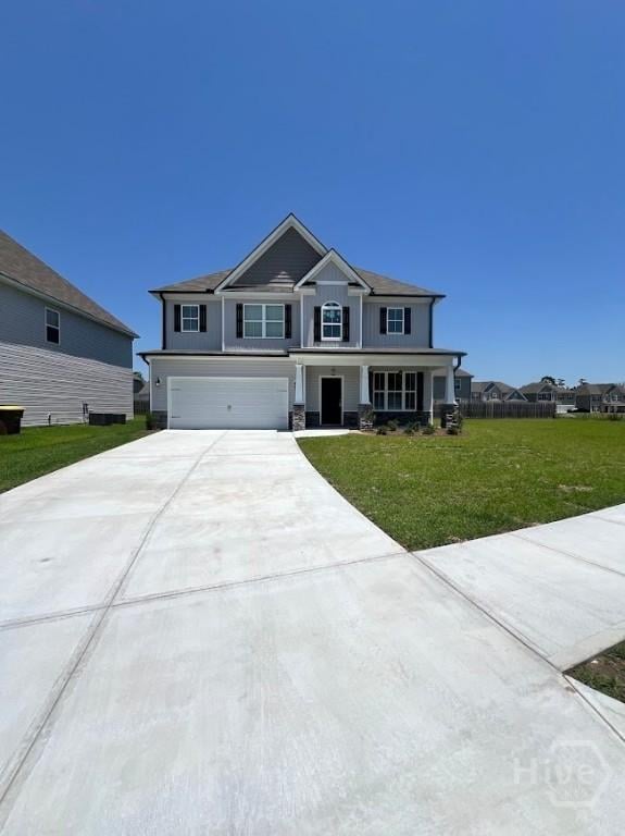 139 Sams Dr, Guyton, GA 31312 - craftsman inspired home featuring an attached garage, driveway, a front lawn, and covered porch