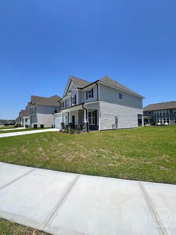 139 Sams Dr, Guyton, GA 31312 - view of side of property featuring driveway and a lawn