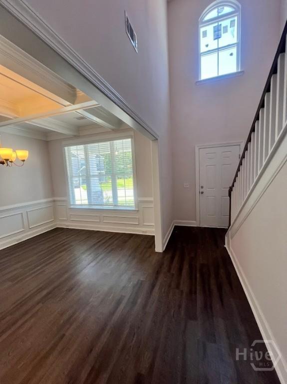 139 Sams Dr, Guyton, GA 31312 - entrance foyer with a chandelier, stairway, dark wood finished floors, beam ceiling, and coffered ceiling