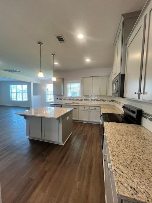 139 Sams Dr, Guyton, GA 31312 - kitchen featuring appliances with stainless steel finishes, healthy amount of natural light, dark wood-type flooring, a kitchen island, and recessed lighting