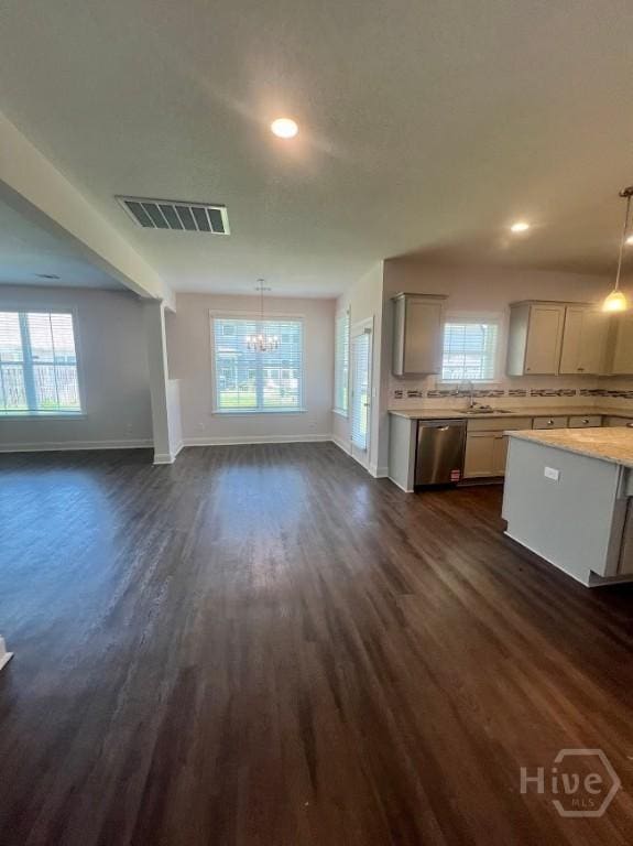 139 Sams Dr, Guyton, GA 31312 - unfurnished living room with baseboards, dark wood-type flooring, a chandelier, recessed lighting, and a sink