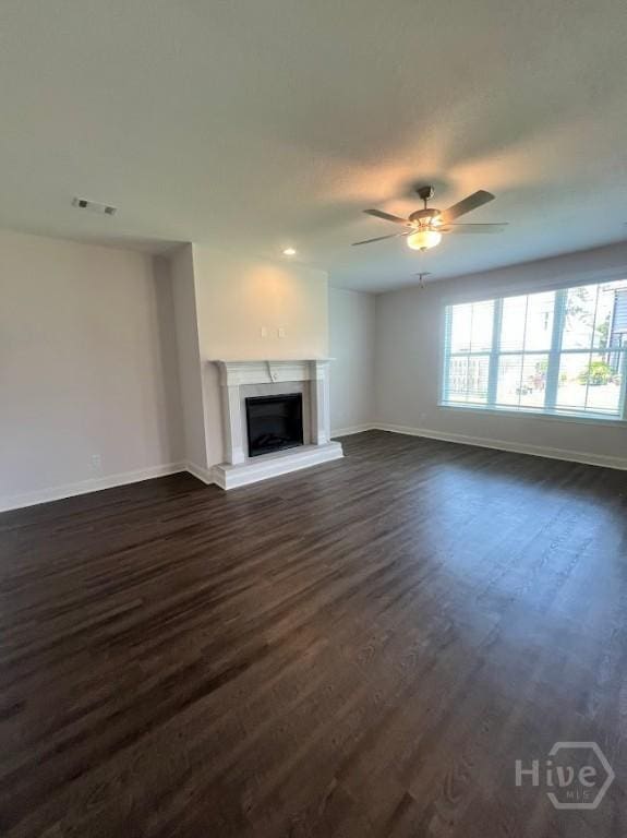 139 Sams Dr, Guyton, GA 31312 - unfurnished living room with baseboards, dark wood-style floors, and ceiling fan