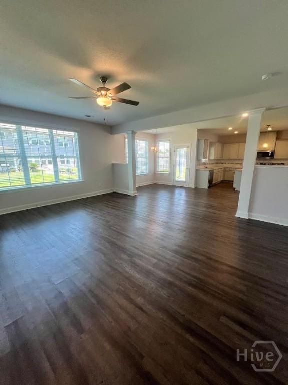 139 Sams Dr, Guyton, GA 31312 - unfurnished living room with baseboards, decorative columns, dark wood-style floors, healthy amount of natural light, and recessed lighting