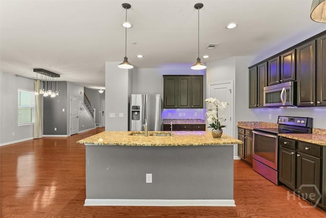 4 Crest View Cir, Pooler, GA 31322 - kitchen featuring stainless steel appliances, wood finished floors, light stone countertops, a center island with sink, and recessed lighting