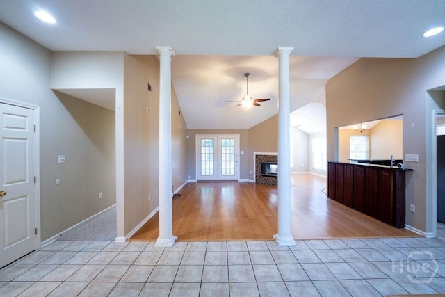 143 Village Lake Dr, Pooler, GA 31322 - unfurnished living room featuring lofted ceiling, light tile patterned flooring, ceiling fan, a fireplace, and baseboards