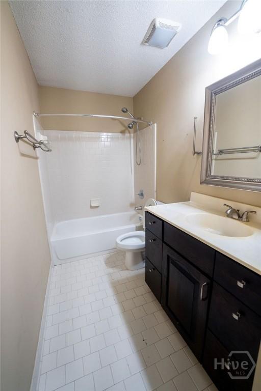 143 Village Lake Dr, Pooler, GA 31322 - bathroom with vanity, toilet, shower / bathtub combination, a textured ceiling, and tile patterned flooring