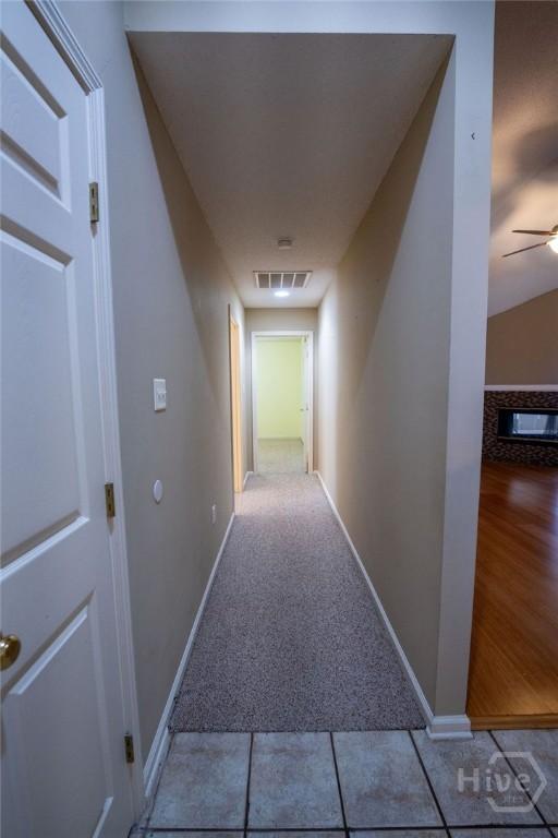 143 Village Lake Dr, Pooler, GA 31322 - hall featuring carpet flooring, baseboards, and tile patterned flooring
