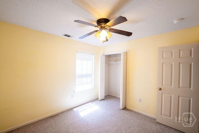 143 Village Lake Dr, Pooler, GA 31322 - unfurnished bedroom featuring light carpet, a closet, baseboards, a ceiling fan, and a textured ceiling