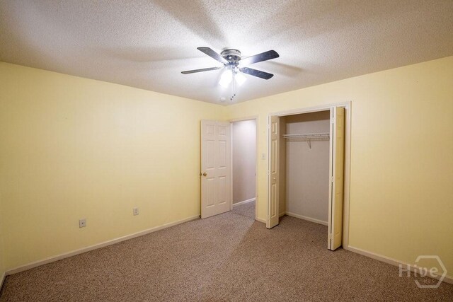 143 Village Lake Dr, Pooler, GA 31322 - unfurnished bedroom featuring light colored carpet, a closet, a ceiling fan, baseboards, and a textured ceiling