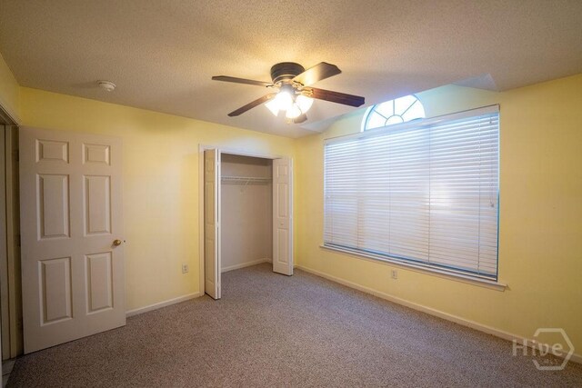143 Village Lake Dr, Pooler, GA 31322 - unfurnished bedroom with carpet flooring, a closet, baseboards, a ceiling fan, and a textured ceiling