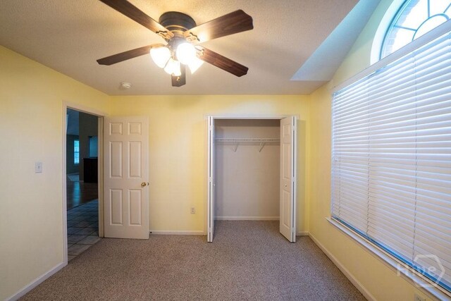 143 Village Lake Dr, Pooler, GA 31322 - unfurnished bedroom with light carpet, ceiling fan, a closet, baseboards, and a textured ceiling
