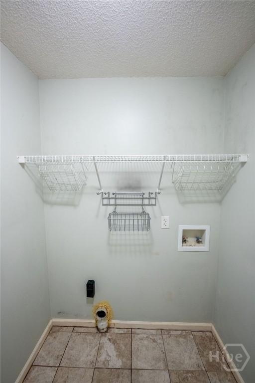 143 Village Lake Dr, Pooler, GA 31322 - laundry area featuring washer hookup, a textured ceiling, baseboards, and hookup for an electric dryer