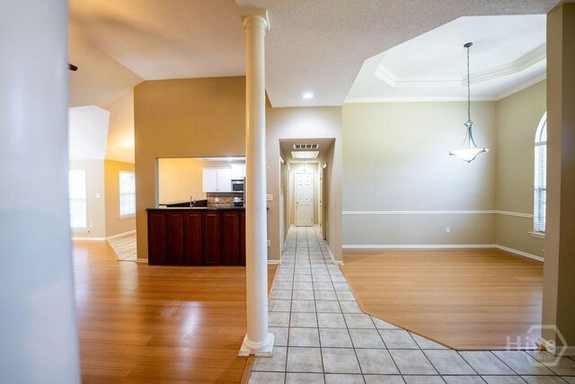143 Village Lake Dr, Pooler, GA 31322 - entrance foyer featuring crown molding, light wood finished floors, baseboards, ornate columns, and a raised ceiling