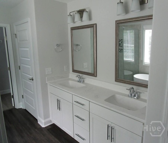 32 Brookhaven Dr, Savannah, GA 31407 - full bath featuring a stall shower, double vanity, a freestanding bath, wood finished floors, and baseboards
