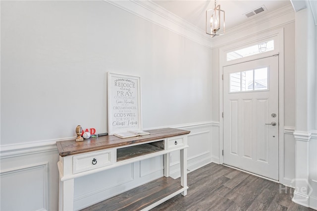 32 Brookhaven Dr, Savannah, GA 31407 - foyer entrance with ornamental molding, dark wood finished floors, wainscoting, a chandelier, and a decorative wall