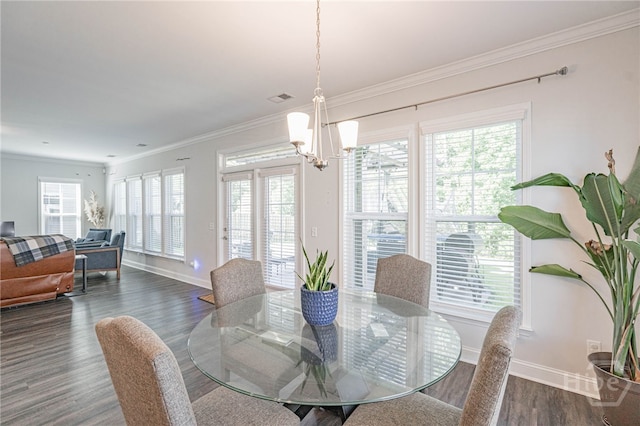 32 Brookhaven Dr, Savannah, GA 31407 - dining area with a chandelier, dark wood-style flooring, healthy amount of natural light, and crown molding