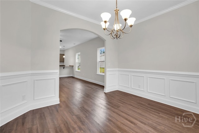 142 Guana Ln, Bloomingdale, GA 31302 - empty room featuring arched walkways, a chandelier, dark wood finished floors, wainscoting, and crown molding