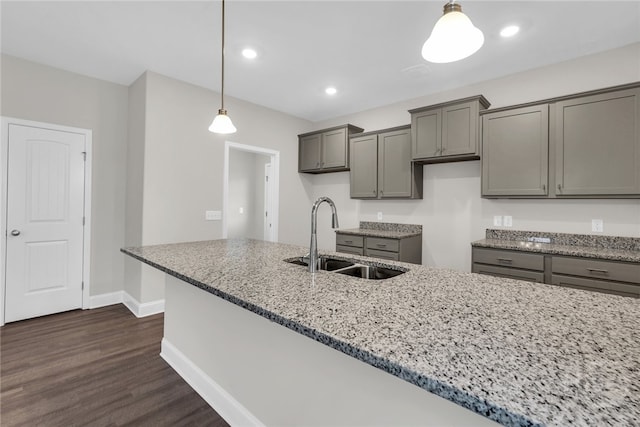 142 Guana Ln, Bloomingdale, GA 31302 - kitchen with a sink, light stone counters, baseboards, dark wood-style floors, and recessed lighting