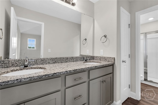 142 Guana Ln, Bloomingdale, GA 31302 - full bath with double vanity, toilet, wood finished floors, a shower stall, and baseboards