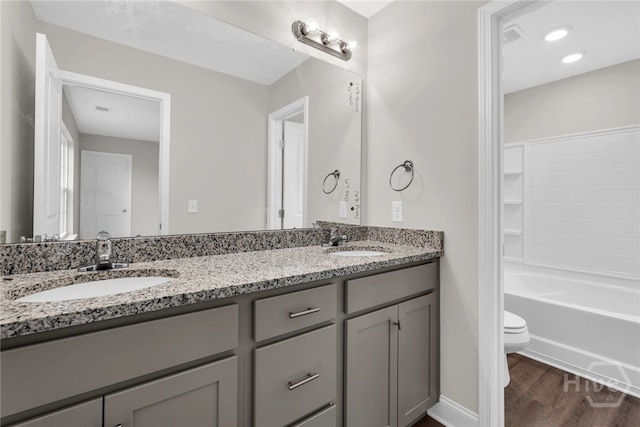 142 Guana Ln, Bloomingdale, GA 31302 - full bath featuring toilet, double vanity, wood finished floors, and baseboards