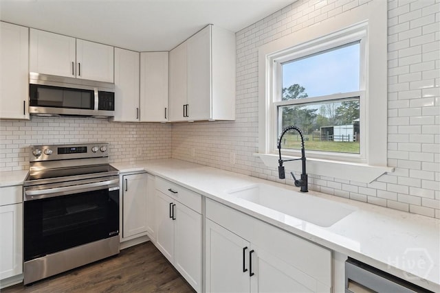 4342 Mud Rd, Brooklet, GA 30415 - kitchen featuring stainless steel appliances, a sink, tasteful backsplash, and white cabinets