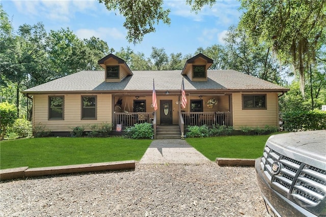124 Denham Ln, Midway, GA 31320 - view of front of house with a porch, a front yard, and a shingled roof