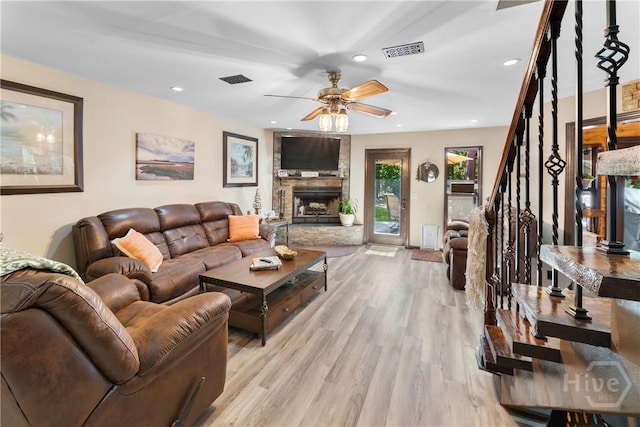 124 Denham Ln, Midway, GA 31320 - living room featuring a ceiling fan, light wood-style floors, stairs, a stone fireplace, and recessed lighting