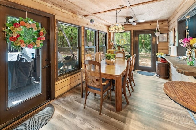 124 Denham Ln, Midway, GA 31320 - sunroom / solarium with wooden walls, plenty of natural light, and wood finished floors