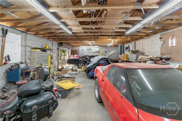 124 Denham Ln, Midway, GA 31320 - garage featuring concrete block wall and a workshop area