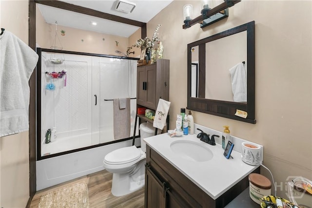 124 Denham Ln, Midway, GA 31320 - full bathroom featuring vanity, wood finished floors, combined bath / shower with glass door, and toilet