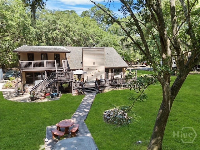 124 Denham Ln, Midway, GA 31320 - rear view of property featuring a wooden deck, a lawn, stairs, and roof with shingles