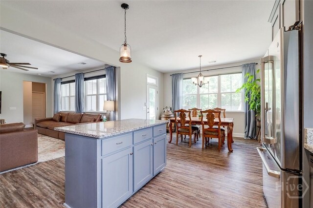 109 Amelia Ct, Guyton, GA 31312 - kitchen featuring freestanding refrigerator, dark wood-type flooring, hanging light fixtures, and a chandelier