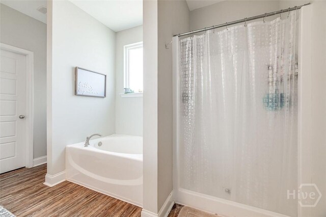 109 Amelia Ct, Guyton, GA 31312 - bathroom with baseboards, wood finished floors, a bath, and curtained shower