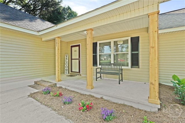 121 Warner Dr, Guyton, GA 31312 - doorway to property with roof with shingles and a porch