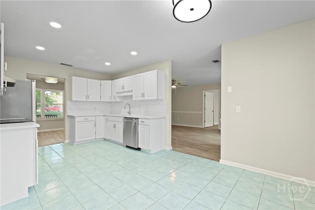 121 Warner Dr, Guyton, GA 31312 - kitchen with stainless steel appliances, white cabinets, light countertops, a ceiling fan, and baseboards
