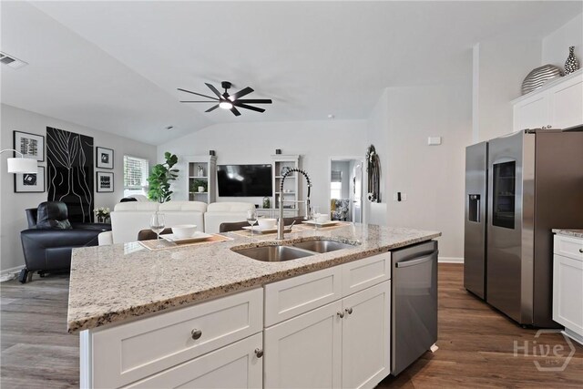 235 Cromer St, Savannah, GA 31407 - kitchen featuring appliances with stainless steel finishes, a sink, open floor plan, white cabinets, and lofted ceiling