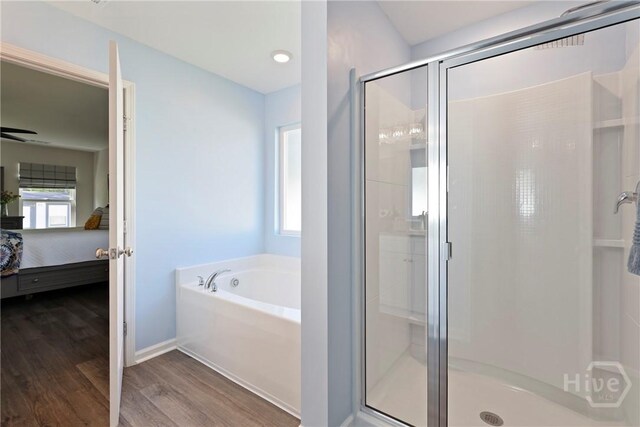 235 Cromer St, Savannah, GA 31407 - ensuite bathroom featuring a garden tub, a shower stall, and wood finished floors
