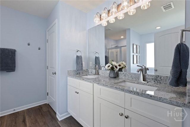 235 Cromer St, Savannah, GA 31407 - bathroom featuring double vanity, wood finished floors, a shower stall, and baseboards