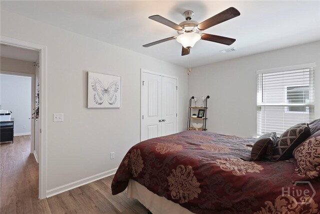 235 Cromer St, Savannah, GA 31407 - bedroom with wood finished floors, baseboards, a closet, and ceiling fan