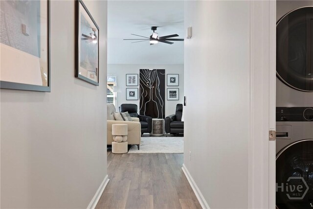 235 Cromer St, Savannah, GA 31407 - hallway featuring estacked washer and dryer, wood finished floors, and baseboards