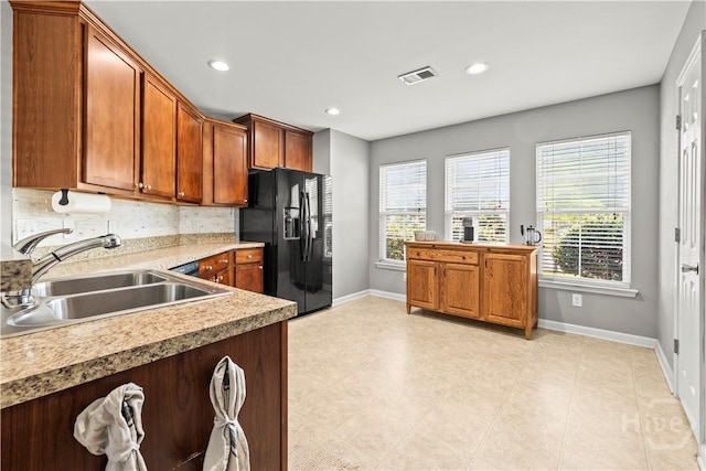 46 Central Park Way, Savannah, GA 31407 - kitchen with black fridge, a sink, baseboards, healthy amount of natural light, and recessed lighting