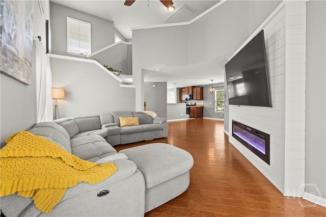46 Central Park Way, Savannah, GA 31407 - living room with dark wood-type flooring, a fireplace, a ceiling fan, and baseboards