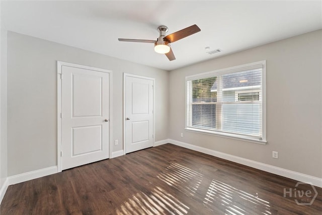 2142 New York Ave, Savannah, GA 31404 - unfurnished bedroom with baseboards, wood finished floors, and a ceiling fan
