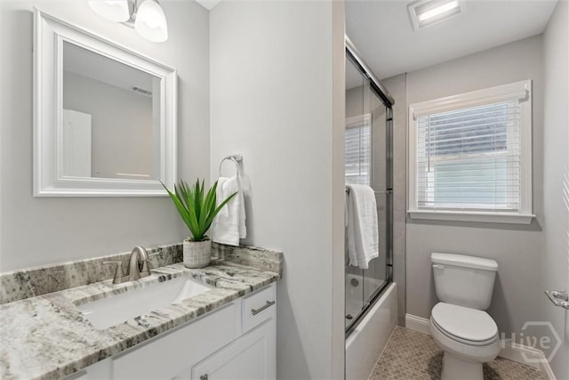 2142 New York Ave, Savannah, GA 31404 - full bathroom with vanity, toilet, baseboards, shower / bath combination with glass door, and tile patterned flooring