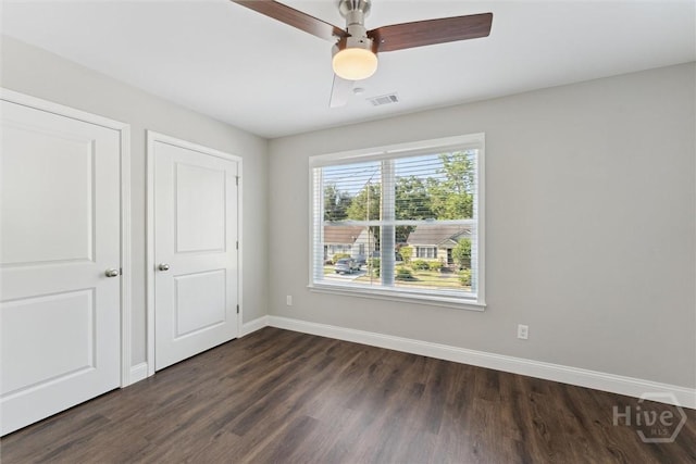 2142 New York Ave, Savannah, GA 31404 - unfurnished bedroom featuring dark wood finished floors, baseboards, and a ceiling fan