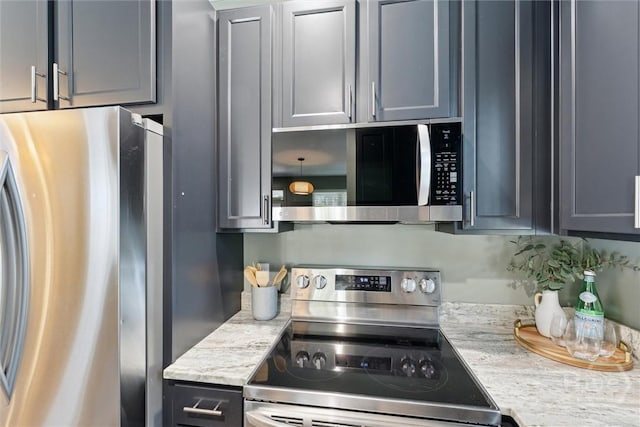 2142 New York Ave, Savannah, GA 31404 - kitchen with stainless steel appliances, gray cabinets, and light stone counters