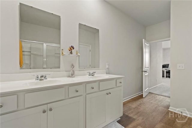 116 Fremont Ln, Pooler, GA 31322 - bathroom with double vanity, a shower with door, wood finished floors, and baseboards