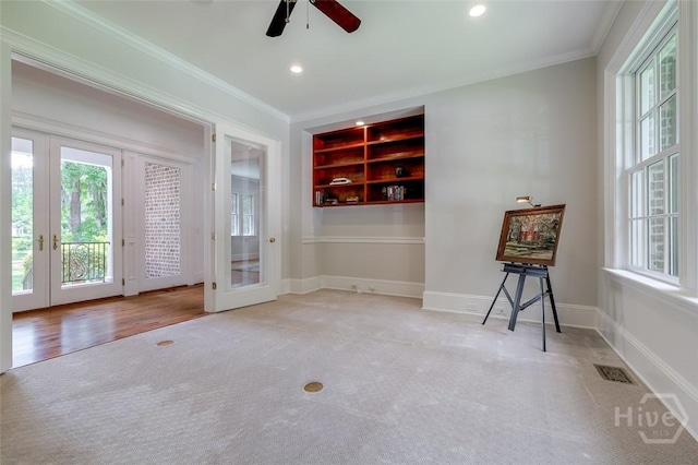 36 Belted Kingfisher Ln, Richmond Hill, GA 31324 - carpeted spare room featuring french doors, ornamental molding, a ceiling fan, built in features, and baseboards